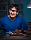 Student preparing for exams late at night in library Royalty Free Stock Photo
