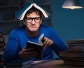 Student preparing for exams late at night in library Royalty Free Stock Photo