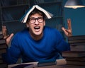 Student preparing for exams late at night in library Royalty Free Stock Photo