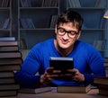 Student preparing for exams late at night in library Royalty Free Stock Photo