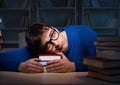 Student preparing for exams late at night in library Royalty Free Stock Photo