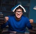 Student preparing for exams late at night in library Royalty Free Stock Photo