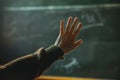 Student raising hand answering question on chalkboard Royalty Free Stock Photo