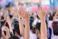 Student raising hands at high school.