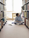 Student Reaching For Book In Library Royalty Free Stock Photo