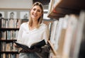 Student, reading or books in library on school, university or college campus for education, study research or learning Royalty Free Stock Photo