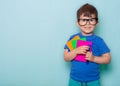 Student ready for school. Children`s Stationery for school. Kid with notebook and pen in hands.