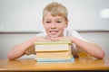 Student resting thie head upon some books