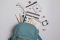 Student`s backpack with different stationery and study supplies on the white background Royalty Free Stock Photo