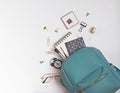 Student`s backpack with different stationery and study supplies on the white background Royalty Free Stock Photo