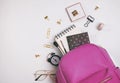 Student`s backpack with different stationery and study supplies on the white background Royalty Free Stock Photo