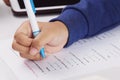 Student`s hand taking English test in class