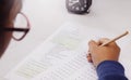 Student`s hand taking English test in class