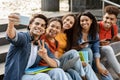 Student& x27;s Selfie. Multiethnic group of college friends taking photo together on smartphone Royalty Free Stock Photo