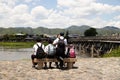 Student schoolchildren are sitting on a bench near Katsura river, Kyoto, Japan