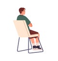 Student on seat listens to lecture, seminar back view. Attentive spectator sits on chair, watching public performance