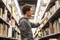 Student selecting a book in a library Royalty Free Stock Photo