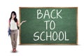 Student showing back to school text Royalty Free Stock Photo