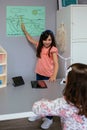 Student showing types of renewable energies in poster at ecology classroom Royalty Free Stock Photo