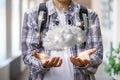 Student shows the brain in the form of cloud computing on blurred background