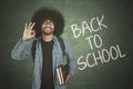 Student shows ok sign with back to school text Royalty Free Stock Photo