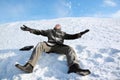 Student sits on snow and merrily throw him