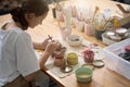 Student sits at the table and paints a plate Royalty Free Stock Photo