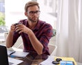 Student sitting at a desk with coffee in his hands Royalty Free Stock Photo