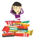 Student sitting in huge pile of books.