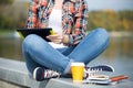 Student sitting turkish at bridge with tablet