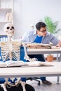 The student skeleton listening to lecture in classroom Royalty Free Stock Photo