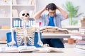 The student skeleton listening to lecture in classroom Royalty Free Stock Photo