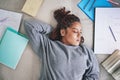 Student, sleeping and burnout with study books on house living room, home interior and bedroom floor. Top view of black Royalty Free Stock Photo