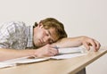 Student sleeping at desk in classroom Royalty Free Stock Photo