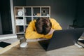 The student sleeps at the desk during home distance learning. Sleepy student sleeps at home at the study desk in quarantine near Royalty Free Stock Photo