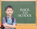 Student smiling in front of chalkboard Royalty Free Stock Photo