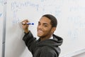 Student Solving Algebra Equation On Whiteboard