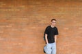 Student standing in front of brick wall Royalty Free Stock Photo