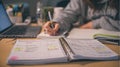 Student studying with laptop and notebooks on a desk, writing notes for school assignments at home Royalty Free Stock Photo
