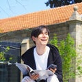 The student is studying on the street