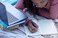 Student, studying and woman writing notes from research assignment for college or university academic education. Park Royalty Free Stock Photo