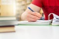 Student studying and writing notes in public or school library Royalty Free Stock Photo