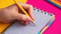 Student Takes Notes in a Colorful Planner Against a Vibrant Background With Ample Blank Space on the Right Side for Royalty Free Stock Photo