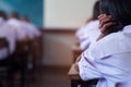 Student taking exam with stress in school classroom Royalty Free Stock Photo