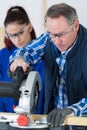 Student and teacher in carpentry class using circular saw Royalty Free Stock Photo