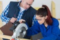 student and teacher in carpentry class using circular saw Royalty Free Stock Photo