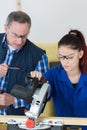 Student and teacher in carpentry class using circular saw Royalty Free Stock Photo