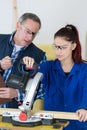 Student and teacher in carpentry class using circular saw Royalty Free Stock Photo