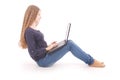 Student teenage girl sitting sideways on the floor with laptop Royalty Free Stock Photo