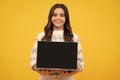 Student teenager schoolgirl with laptop on isolated background. Screen of laptop computer with copyspace mockup. Online Royalty Free Stock Photo